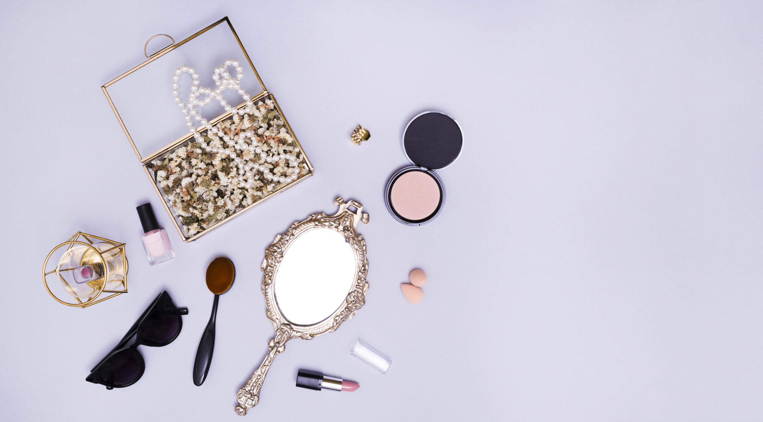 necklace-flowers-box-lipstick-blender-sunglasses-oval-comb-compact-powder-lipstick-hand-mirror-purple-background